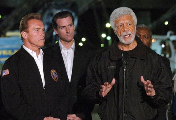 Apr 29, 2007 - Oakland, CA, USA - Oakland Mayor RON DELLUMS (right) speaks while Governor ARNOLD SCHWARZENEGGER (left) and San Francisco Mayor Gavin newsom listen at the site of a collapsed overpass in Oakland, Calif. on Sunday, April 29, 2007. The collapse, caused by a tanker truck that crashed and exploded, is on top of Westbound I-80 to Southbound I-880 and the intersection of Eastbound I-80 and Westbound I-580. - ZUMAc99_ 20070429_mkh_c99_779