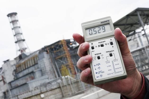 Apr 29, 2007 - Chernobyl, Ukraine - A dosimeter shows the current radiation level outside the Chernobyl Nuclear Power Plant. In the background is Fourth Block of the plant, where the Chernobyl accident occurred on April 26, 1986 during an ill-advised late night safety test. After 21 years, the radiation outside the plant remains high enough that stopping here for more than a brief period is not recommended. Nevertheless, this site is one of many which tourists visit during a one-day excursion into the Exclusion Zone. Chernobyl has become one of Ukraine s hottest tourist destinations. The Exclusion Zone with highest Chernobyl contamination covers 819 square miles. In total, radioactive fallout contaminated 56,700 square miles of Ukraine, Russia and Belarus, a region home to six million people. - ZUMAmr6_ 20070429_rua_mr6_029