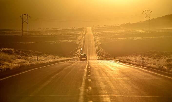July 13, 2016 - Eureka, Nevada, U.S. - A motorist travels along U.S. Highway 50 at sunrise west of Eureka, Nevada. Since a 1986 Life magazine which dubbed the Nevada portion of the road The Loneliest Road in America, state tourism officials created a program for motorists to travel the sometime isolated highway. Eureka USA - ZUMAbk3_ 20160713_zaf_bk3_002