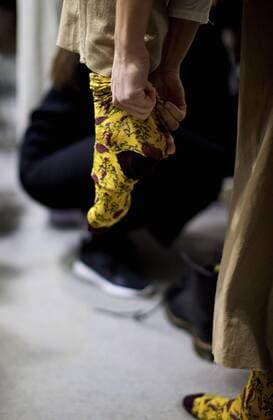 MILAN, Jan. 16, 2017 -- A model puts on a pair of jacquard socks at backstage ahead of the Fall Winter 2017 18 menswear collection of MIAORAN during Milan Fashion Week in Milan, Italy, on Jan. 16, 2017. )(gl) ITALY-MILAN-FASHION WEEK-MEN-CHINESE DESIGNER-MIAORAN JinxYu 
