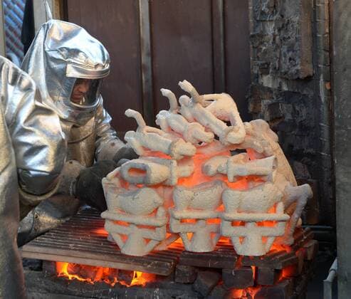 Workers in fire suits pour molten bronze metal into molds during the casting of the Screen Actors Guild Award statuettes at the American Fine Arts Foundry in Burbank, California on January 17, 2017. Winners are to be announced during a live simulcast on TNT and TBS in Los Angeles on January 29, 2017.  LAP2017011701 JIMxRUYMEN
