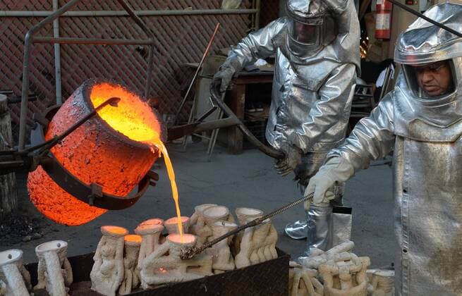 Workers in fire suits pour molten bronze metal into molds during the casting of the Screen Actors Guild Award statuettes at the American Fine Arts Foundry in Burbank, California on January 17, 2017. Winners are to be announced during a live simulcast on TNT and TBS in Los Angeles on January 29, 2017.  LAP2017011704 JIMxRUYMEN