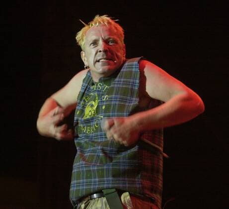 (published 09 08 2003, D-1:1,3; SignOn Gallery: 09 15 2003) John Lydon, aka Johnny Rotten, does his best gorilla imitation during a Sex Pistols performance Sunday night at Street Scene. Peggy Peattie photo - ZUMAs44_ 20060712_aag_s44_694