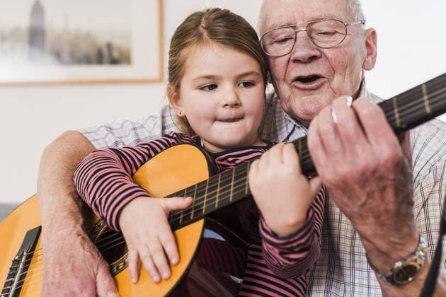 Grandfather and granddaughter playing together guitar model released Symbolfoto property released  UUF09553