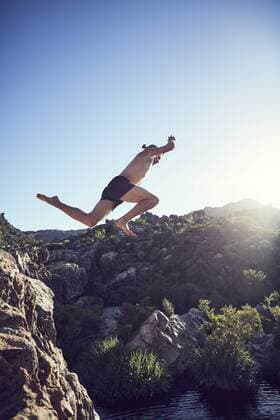 South Africa, Porterville, Beaverlac, man jumping from rock into water model released Symbolfoto  SRYF00188