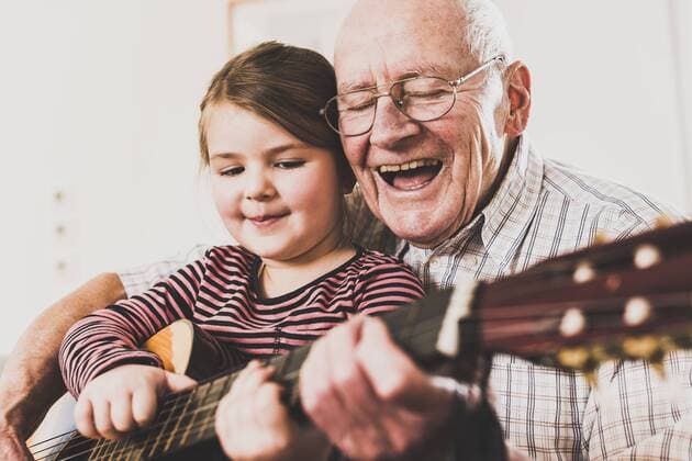 Grandfather and granddaughter playing together guitar model released Symbolfoto property released  UUF09554