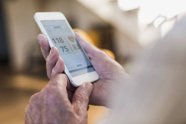 Senior man using smart phone app model released Symbolfoto property released  UUF09576