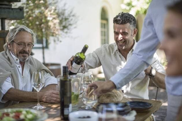 Father and son having wine enjoying family lunch together model released Symbolfoto property released  ZEF12389