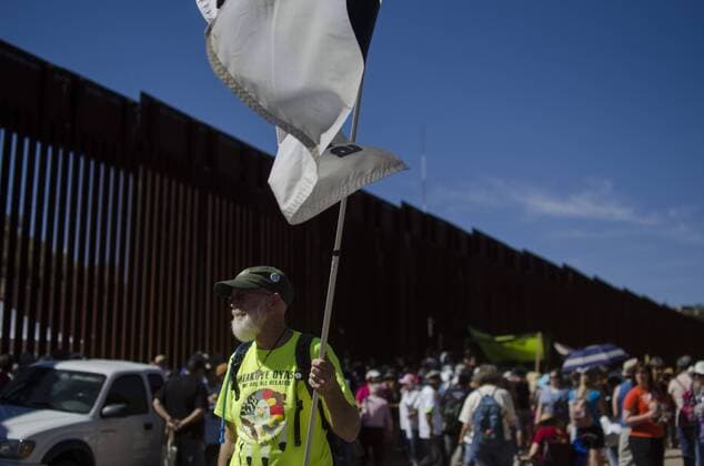 January 25, 2107 - File - President Trump signed executive orders to begin the construction of a wall on the US-Mexico border, boosting border patrol forces and increasing the number of immigration enforcement officers who carry out deportations. Pictured: October 9, 2016 - Nogales, Arizona, U.S - MARTIN BATES of the Northern Colorado Veterans for Peace Chapter 178 holds a flag in front of the U.S. Mexico border wall. Hundreds of activists converged in Nogales, Arizona and Nogales, Sonora (Mexico) to take part in the School of the Americas Watch Border Encuentro October 7-10. Among other issues, demonstrators denounced U.S. military and economic policy in Latin America, as well as the militarization of the border and the treatment of migrants. Nogales U.S. - ZUMAh126 20170125_sho_h126_111 Copyright: xGrahamxCharlesxHuntx