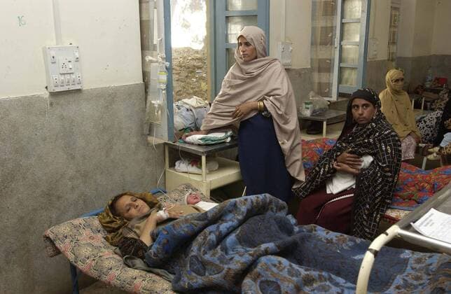 Oct 22, 2005; Mansehra, Kashmir, PAKISTAN; Mansehra District Hospital had to be evacuated after the Pakistani earthquake that devastated the region on Oct. 8, 2005. Now, 350 patients are in tents and in the open air. The hospital is not safe and will be torn down. UNFPA, the United Nations Population Fund, was the first to respond with first aid and life saving medicines. UNFPA has also set up 100 tents for the patients and will reconstruct the Obstetrics Gynocology ward of the Hospital. Pictured is a women in this ward that had given birth two hours earlier. Mandatory - ZUMAz03_ 20051022_mkh_z03_601 Copyright: xEvanxSchneider UNxPhotox