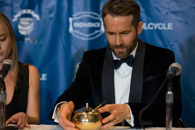 Actor Ryan Reynolds looks at his Pudding Pot trophy during a press conference after Reynolds was awarded the Harvard University Hasty Pudding Theatricals 2017 Man of the Year inside Farkas Hall in Cambridge, Massachusetts on February 3, 2017.  BOS20170203011 MATTHEWxHEALEY