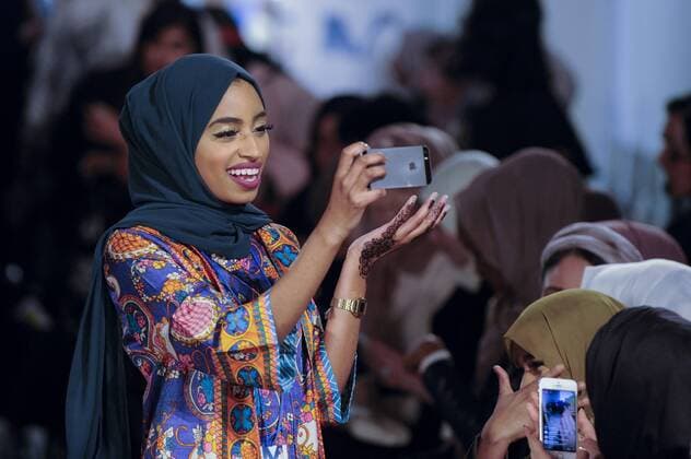 February 18, 2017 - London, UK - London, UK. A woman in the audience awaits the first catwalk of the day at the UK s first London Modest Fashion Week taking place this weekend at the Saatchi Gallery. The two day event sees 40 brands from across the world come together to showcase their collections for Muslim and other religious women. London UK  - ZUMAl94_ 20170218_zaf_l94_030 Copyright: xStephenxChungx