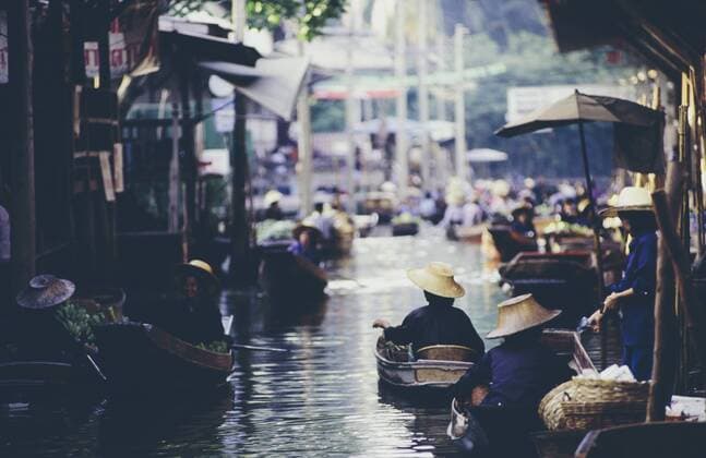 Damnoen Saduak Floating Market, a woman selling goods from boats in floating market Damnoen Saduak Floating Market, a woman selling goods from boats in floating market  27394