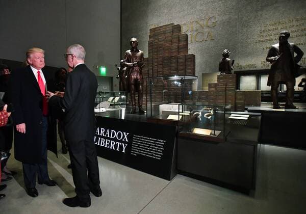 President Donald Trump visits the Smithsonian National Museum of African American History and Culture in Washington, DC on February 21, 2017. The Paradox of Liberty exhibit at right shows President Thomas Jefferson and other American leaders with slaves, each brick being a slave.  WAP2017022102 KEVINxDIETSCH