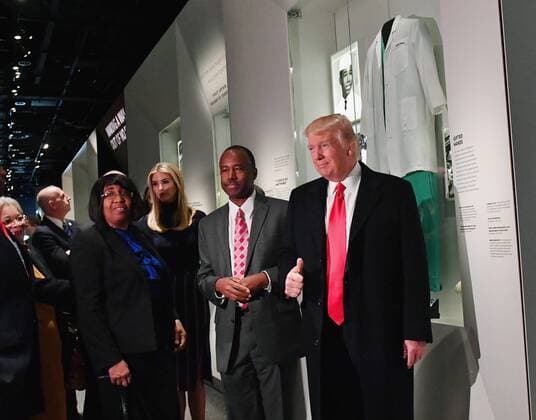 President Donald Trump looks at the Ben Carson exhibit with Ben Carson and Ivanka Trump (center) as he visits the Smithsonian National Museum of African American History and Culture in Washington, DC on February 21, 2017.  WAP2017022105 KEVINxDIETSCH