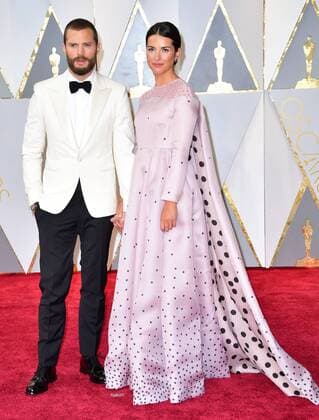 Actors Jamie Dornan and Amelia Warner arrives on the red carpet for the 89th annual Academy Awards at the Dolby Theatre in the Hollywood section of Los Angeles on February 26, 2017.  LAX20170226910 KEVINxDIETSCH