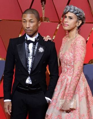 Musician Pharrell Williams (L) and producer Mimi Valdez arrive on the red carpet for the 89th annual Academy Awards at the Dolby Theatre in the Hollywood section of Los Angeles on February 26, 2017.  LAP20170226084 JIMxRUYMEN