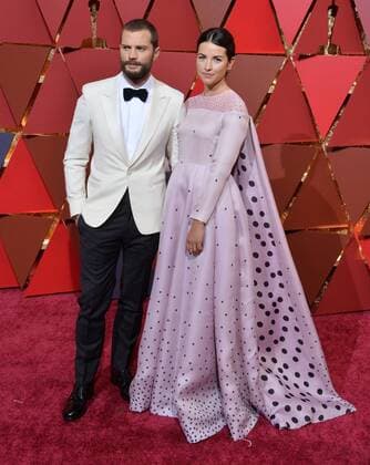 Actors Jamie Dornan (L) and Amelia Warner arrive on the red carpet for the 89th annual Academy Awards at the Dolby Theatre in the Hollywood section of Los Angeles on February 26, 2017.  LAP201702264001 JIMxRUYMEN