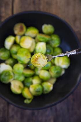 Half of fried Brussels sprout on fork, close-up  LVF05847