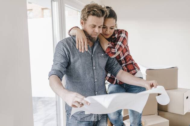 Couple looking at floor plan of theit new home model released Symbolfoto property released  JOSF00503