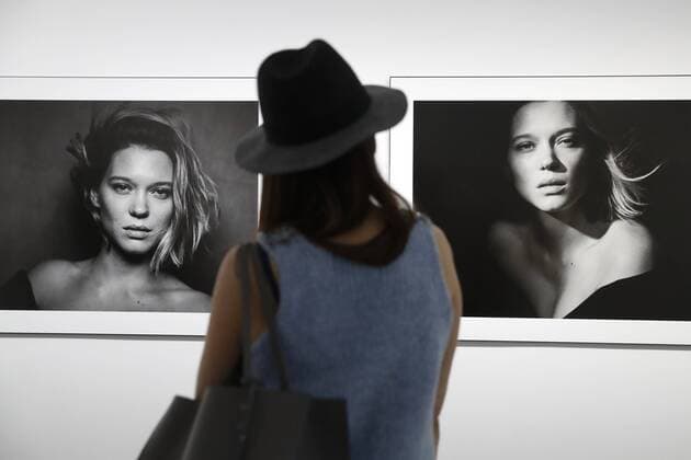 MOSCOW, RUSSIA - MARCH 16, 2017: A woman looks at photos of actress Lea Seydoux displayed at the â€˜Pirelli Calendar 2017 by Peter Lindberghâ€™ exhibition at Moscowâ€™s Multimedia Art Museum. The exhibition is open from March 17 to May 14, 2017. Artyom Geodakyan TASS  TS04485D