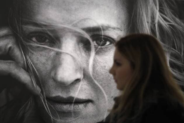 MOSCOW, RUSSIA - MARCH 16, 2017: A woman walks past a photo of actress Uma Thurman displayed at the â€˜Pirelli Calendar 2017 by Peter Lindberghâ€™ exhibition at Moscowâ€™s Multimedia Art Museum. The exhibition is open from March 17 to May 14, 2017. Artyom Geodakyan TASS  TS044861