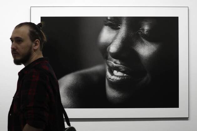 MOSCOW, RUSSIA - MARCH 16, 2017: A man walks past a photograph of actress Lupita Nyong o taken for the 2017 Pirelli Calendar on display at an exhibition titled Pirelli Calendar 2017 by Peter Lindbergh at Moscow s Multimedia Art Museum. The exhibition is open from March 17 to May 14, 2017. Artyom Geodakyan TASS  TS04485E