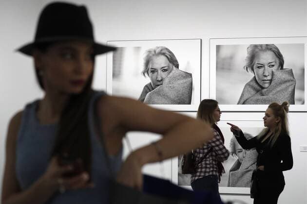 MOSCOW, RUSSIA - MARCH 16, 2017: Visitors by photographs of actress Helen Mirren taken for the 2017 Pirelli Calendar on display at an exhibition titled Pirelli Calendar 2017 by Peter Lindbergh at Moscow s Multimedia Art Museum. The exhibition is open from March 17 to May 14, 2017. Artyom Geodakyan TASS  TS04485F