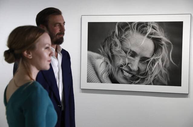 MOSCOW, RUSSIA - MARCH 16, 2017: Visitors by a photograph of actress Uma Thurman taken for the 2017 Pirelli Calendar on display at an exhibition titled Pirelli Calendar 2017 by Peter Lindbergh at Moscow s Multimedia Art Museum. The exhibition is open from March 17 to May 14, 2017. Artyom Geodakyan TASS  TS04486A