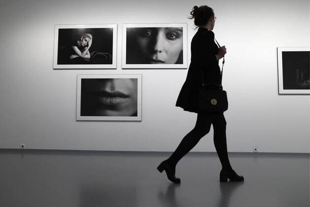 MOSCOW, RUSSIA - MARCH 16, 2017: A woman walks past photographs of actress Rooney Mara taken for the 2017 Pirelli Calendar on display at an exhibition titled Pirelli Calendar 2017 by Peter Lindbergh at Moscow s Multimedia Art Museum. The exhibition is open from March 17 to May 14, 2017. Artyom Geodakyan TASS  TS04486B