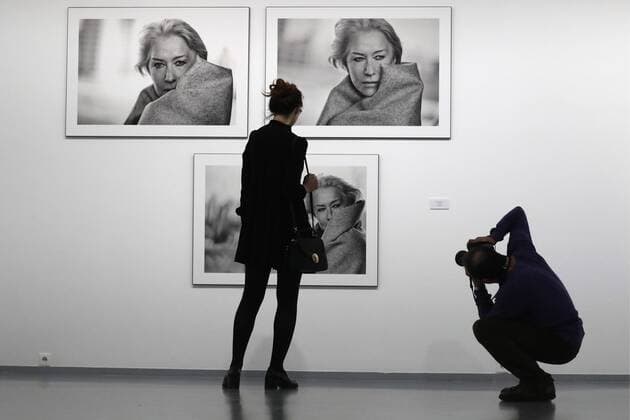 MOSCOW, RUSSIA - MARCH 16, 2017: Visitors by photographs of actress Helen Mirren taken for the 2017 Pirelli Calendar on display at an exhibition titled Pirelli Calendar 2017 by Peter Lindbergh at Moscow s Multimedia Art Museum. The exhibition is open from March 17 to May 14, 2017. Artyom Geodakyan TASS  TS04486D