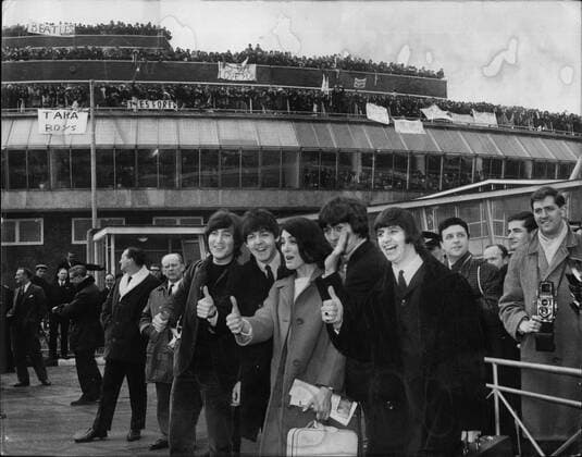 Feb. 02, 1965 - The Beatles Fly To The Bahamas For New Film. Thumbs UP . At London Airport: The Beatles left London Airport this afternoon for the Bahamas - for shooting of their Is test film. They were accompanied by Eleanor Bron - star of the BBC show Not So Much a programmer . She will be appearing in the film with Ring-Paul-George and John. Photo shows Thumbs up - as the Beatles - with Eleanor Bron get a rousing farewell from their fans - in background - at London Airport this morning. - ZUMAk09_ 19650202_baf_k09_011 Copyright: xKeystonexPressxAgencyx
