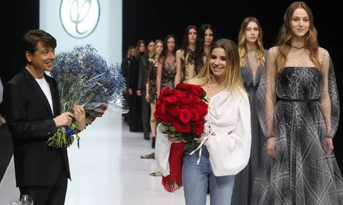 MOSCOW, RUSSIA - MARCH 21, 2017: Russian fashion designer Valentin Yudashkin and his daughter Galina receive flowers after a runway show for Yudashkin s Fall Winter 2017 collection titled Faberlic at the 37th Moscow Fashion Week at Moscow s Gostiny Dvor Shopping and Exhibition Centre. Stanislav Krasilnikov TASS  TS045044