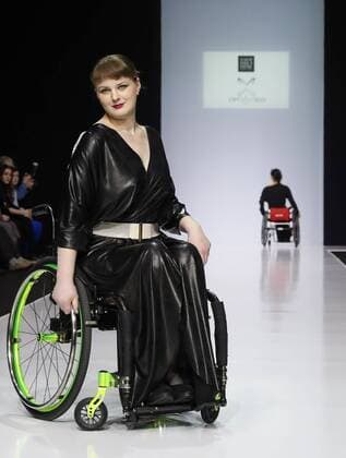 MOSCOW, RUSSIA - MARCH 23, 2017: A model in a wheelchair showcases a creation during a catwalk show for the NP Open World collection at the Moscow Fashion Week, at the Gostiny Dvor Shopping and Exhibition Centre. Open World is a non-profit partnership helping integrate people with disabilities. Vyacheslav Prokofyev TASS  TS04534C