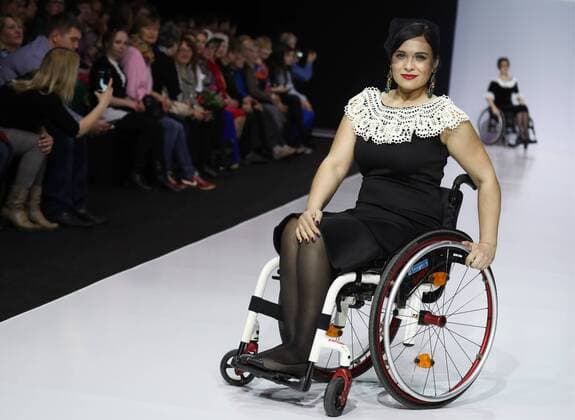 MOSCOW, RUSSIA - MARCH 23, 2017: A model in a wheelchair showcases a creation during a catwalk show for the NP Open World collection at the Moscow Fashion Week, at the Gostiny Dvor Shopping and Exhibition Centre. Open World is a non-profit partnership helping integrate people with disabilities. Vyacheslav Prokofyev TASS  TS045355