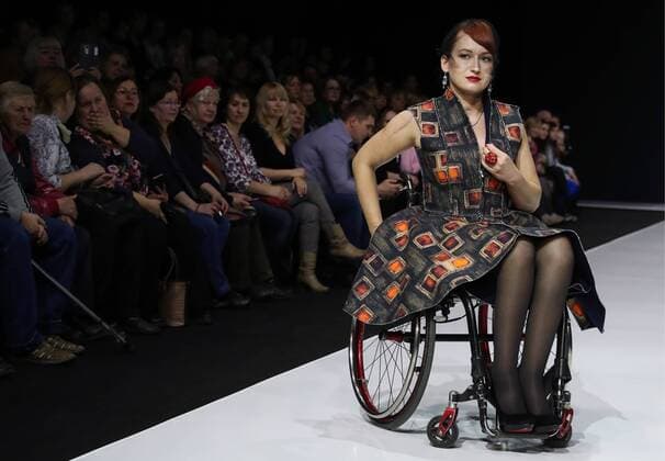 MOSCOW, RUSSIA - MARCH 23, 2017: A model in a wheelchair showcases a creation during a catwalk show for the NP Open World collection at the Moscow Fashion Week, at the Gostiny Dvor Shopping and Exhibition Centre. Open World is a non-profit partnership helping integrate people with disabilities. Vyacheslav Prokofyev TASS  TS045356