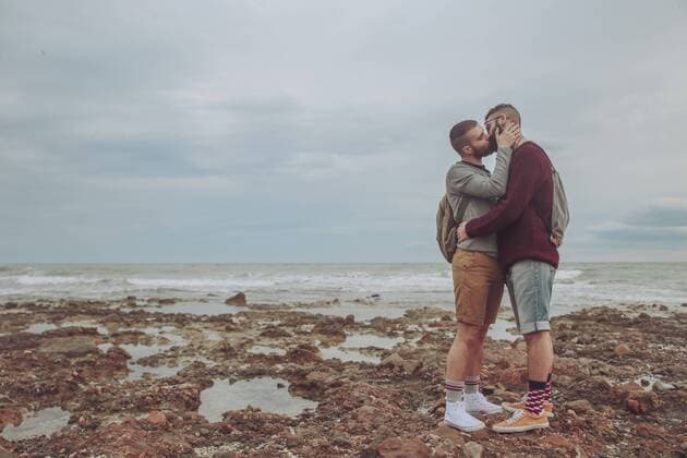 Young gay couple kissing on the beach model released Symbolfoto  RTBF00726