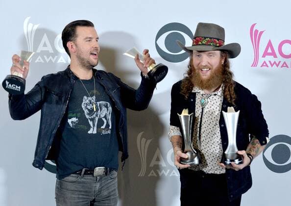 Musicians T.J. Osborne (L) and John Osborne of the music group Brothers Osborne, winners of the Vocal Duo of the Year award, appear backstage during the 52nd annual Academy of Country Music Awards held at T-Mobile Arena in Las Vegas, Nevada on April 2, 2017. The show will be telecast live on CBS.  LVP20170402225 JIMxRUYMEN