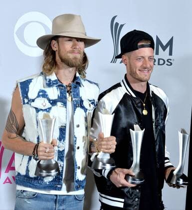 Musicians Tyler Hubbard (L) and Brian Kelley of the music group Florida Georgia Line, winners of the Vocal Event of the Year and Single Record of the Year awards appear backstage during the 52nd annual Academy of Country Music Awards held at T-Mobile Arena in Las Vegas, Nevada on April 2, 2017. The show will be telecast live on CBS.  LVP20170402330 JIMxRUYMEN