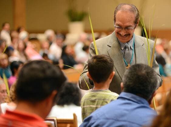 April 9, 2017 - Albuquerque, NEW MEXICO, U.S. - JOURNAL 040917.Usher Gilbert Benavidez,<cq>, hands palms to parishioners before the 12:15 pm Mass at Our Lady of the Most Holy Rosary Catholic Church on Albuquerque West Mesa. Palm Sunday marks the beginning of Holy Week for Christians. Photographed on Sunday April 9, 2017. . JOURNAL. Albuquerque U.S. - ZUMAab1_ 20170409_zaf_ab1_001 Copyright: xAdolphexPierre-Louisx