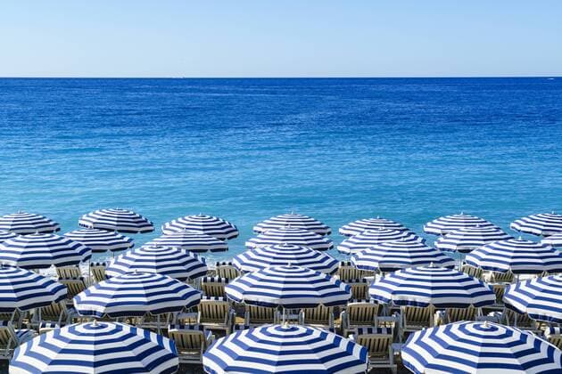 Blue and white beach parasols, Nice, Alpes Maritimes, Cote d Azur, Provence, France, Mediterranean, Europe Copyright: FraserxHall 1226-285