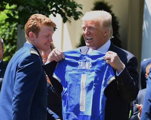 U.S. President Donald Trump is happy with his Air Force jersey after he awarded the Commander-In-Chief Trophy to the U.S. Air Force Academy during ceremony event in the Rose Garden of the White House in Washington, DC on May 2, 2017. The trophy is given annually to the winner of the Army, Navy and Air Force football rivalry.  WAP201705021004 PATxBENIC
