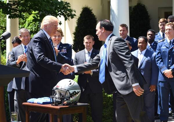 U.S. President Donald Trump shakes hands with the Air Force Academy football team coach Troy Calhoun after he awarded the Commander-In-Chief Trophy to the U.S. Air Force Academy during ceremony event in the Rose Garden of the White House in Washington, DC on May 2, 2017. The trophy is given annually to the winner of the Army, Navy and Air Force football rivalry.  WAP201705021006 PATxBENIC