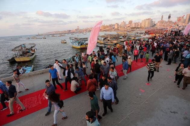 May 12, 2017 - Gaza City, Gaza Strip, Palestinian Territory - Palestinians walk on a red carpet during the 3rd Annual Red Carpet Festival for Human Rights Films at the Gaza seaport, on May 12, 2017. The Red Carpet Festival is held in the Gaza Strip this year for the third year in a raw, amid international and Arab attention. This year, the Hash-Tag of the festival will be Let s go back , which coincides with one hundred years for The Balfour Declaration, where the text of the Balfour Declaration is printed on the carpet Gaza City Palestinian Territory - ZUMAap3_ 20170512_zaf_ap3_026 Copyright: xMohammedxAsadx
