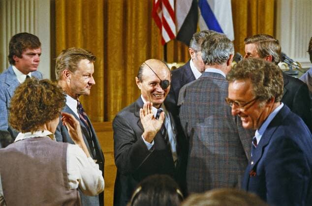 September 17, 1978 - Washington, District of Columbia, United States of America - Foreign Minister Moshe Dayan of Israel waves to an unidentified person prior to the signing ceremony for the Camp David Agreement in the East Room of the White House in Washington, D.C. on Sunday, September 17, 1978. National Security Advisor Zbigniew Brezezinski looks on from left..Credit: CNP Washington United States of America - ZUMAs152 19780917_zaa_s152_001 Copyright: xArniexSachsx