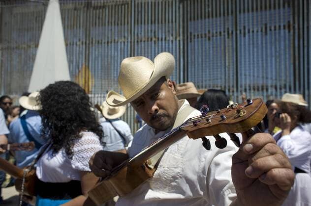 A man tunes his instrument at the U.S.-Mexico border fence during the 10th annual Fandango Fronterizo music event in Tijuana, Mexico, on May 27, 2017. The event featured musicians and dancers who play the traditional Mexican music called Son Jarocho who played simultaneously on both sides of the border fence. Several hundred people came out for the event. 10th annual Fandango Fronterizo music event in Tijuana !ACHTUNG: NUR REDAKTIONELLE NUTZUNG!  Copyright: xDavidxMaungx MEX71 20170528-636315353391984063