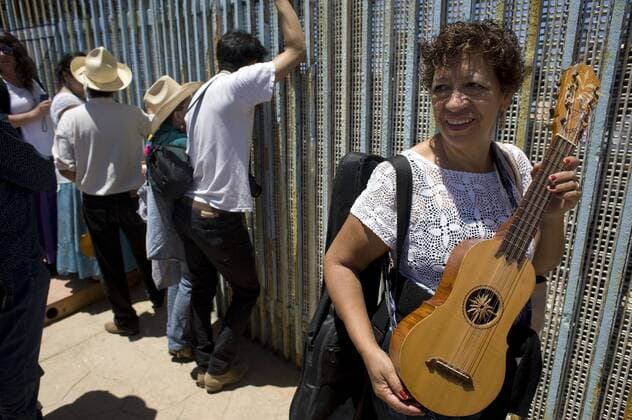 A woman holds her instrument next to the U.S.-Mexico border fence during the 10th annual Fandango Fronterizo music event in Tijuana, Mexico, on May 27, 2017. The event featured musicians and dancers who play the traditional Mexican music called Son Jarocho who played simultaneously on both sides of the border fence. Several hundred people came out for the event. 10th annual Fandango Fronterizo music event in Tijuana !ACHTUNG: NUR REDAKTIONELLE NUTZUNG!  Copyright: xDavidxMaungx MEX71 20170528-636315353411330543