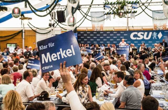 May 28, 2017 - MoÂ¼Nchen, Bayern, Germany - TMerkel in the background. he Bundeskanzlerin (Chancellor) of Germany Angela Merkel (CDU) visited a beer tent in the Trudering district of MunichÃ¢â‚¬â ¢s east end, hosted by her Bavarian sister party, the CSU (Christian Socialist Union). The event was rescheduled from the 23rd due to the terror attack in Manchester. This visit was designed to be a more relaxed affair than previous ones, as MerkelÃ¢â‚¬â ¢s CDU and its branch in Bavaria, the right-conservative CSU, have had antagonistic relations as of late. Despite the negative relations often reported in the media, particularly due to critical statements by CSU head Horst Seehofer, questionnaires reveal 73% of the partyÃ¢â‚¬â ¢s followers back MerkelÃ¢â‚¬â ¢s confirmation for another term. Issues of particular disagreement revolves around refugee policy and the refugee crisis and nationa - ZUMAb160 20170528_zbp_b160_045 Copyright: xSachellexBabbarx
