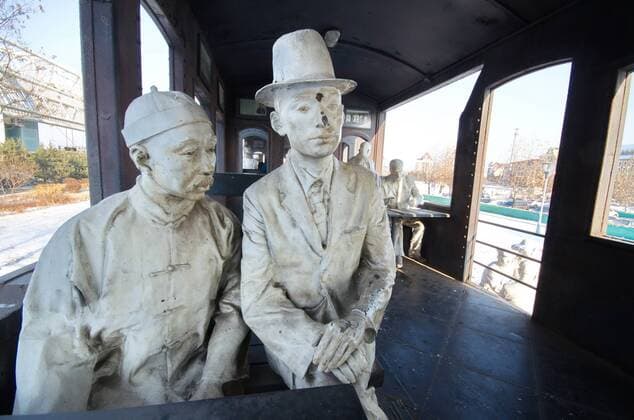 June 16, 2017 - Qinhuangdao, Qinhuangdao, China - Qinhuangdao, CHINA-Jan 17 2016: (EDITORIAL USE ONLY. CHINA OUT) An old train and sculptures of passengers can be seen near the Beidaihe Railway Station in Qinhuangdao, north China s Hebei Province. Qinhuangdao China  - ZUMAs145 20170616_zaa_s145_115 Copyright: xFengxJunx