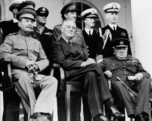 Front row: Marshal Josef Stalin, President Franklin D. Roosevelt, Prime Minister Winston Churchill on the portico of the Russian Embassy. Back row: General H.H. Arnold, Chief of the U.S. Army Air Force; General Alan Brooke, Chief of the Imperial General Staff; Admiral Cunningham, First Sea Lord; Admiral William Leahy, Chief of staff to President Roosevelt, during the Teheran Conference, Teheran, Iran, December, 1943  1003_677THA